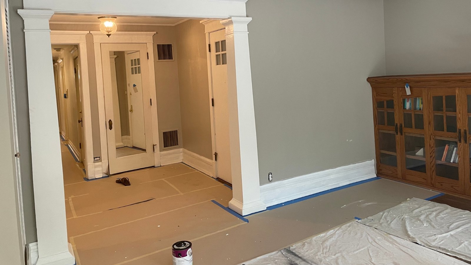 a room with a door and a can of paint